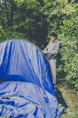 Fototapeta premium Campers setting up a nylon tent in a Camping holidays close to Bristol, England.