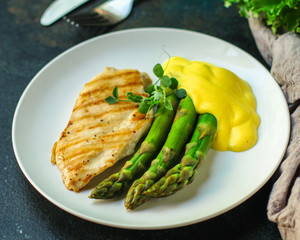 asparagus and chicken breast fillets grill, hollandaise sauce. food background. top
