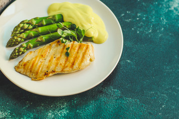 asparagus and chicken breast fillets grill, hollandaise sauce. food background. top
