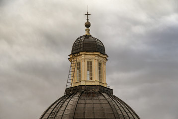 Fototapeta na wymiar Close up of the dome (15th century) of the Cathedral of St Lawrence in the historic centre of Genoa, with a stormy sky background in a rainy day, Liguria, Italy