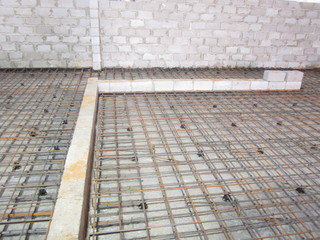 frame made of steel reinforcement for a concrete foundation between the walls of slag blocks