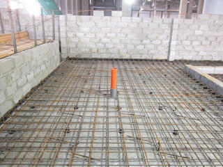 frame made of steel reinforcement for a concrete foundation between the walls of slag blocks