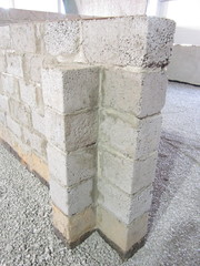 a layer of compacted rubble for pouring concrete between the walls of cinder blocks and panels