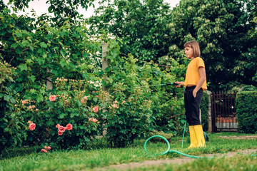 Girl watering flowers in the garden