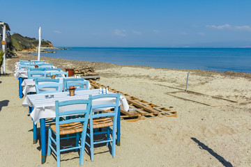 Fototapeta na wymiar Typical Greek restaurant at the beach of Nea Fokea, Kassandra, Chalkidiki, Central Macedonia, Greece