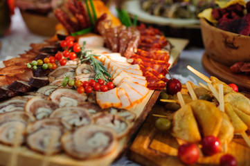 Meat delicatessen in wooden plate. Catering
