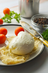 Mozzarella cheese and cherry tomatoes with spices. Homemade mozzarella cheese.