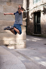 6 Year old boy jumping over stone stairs