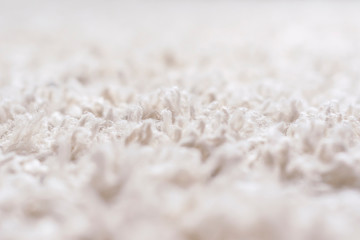 Close-up detail of white shaggy carpet. Terry textile background