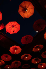 Flying red umbrellas pattern, part of inner courtyard decoration design, by night.