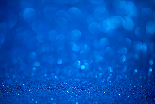 Blue glitter christmas abstract background. Defocused sequin light.