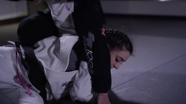 Women training in martial arts in a dojo