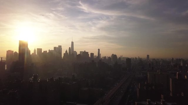 Wide aerial, sun sets over New York City skyline