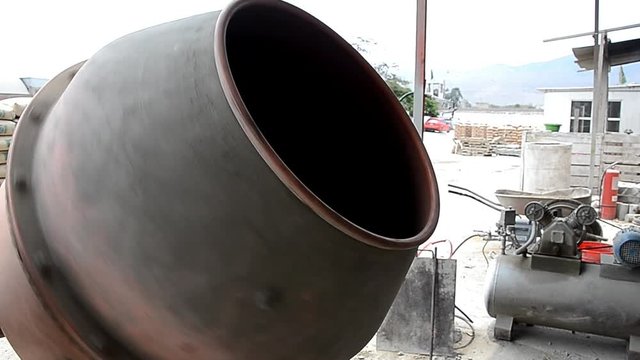 Industrial cement mixer machine at construction site. Concrete pouring. Mixes the sand, gravel and water. Close-up.