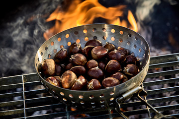 Fresh autumn chestnuts roasting over a fire