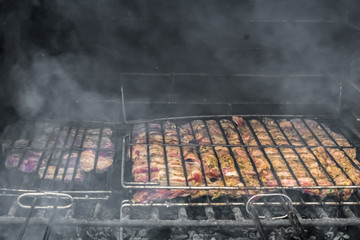 meat cooked on a grill on a metal grill on a stone barbecue