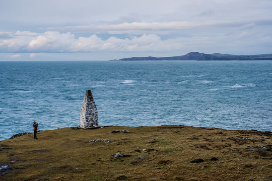 Cardigan Bay and stone cairn marking the entrance to Porthgain Harbour from the Pembrookeshire Coast Trail, Pembrokeshire National Park, Wales, UK.