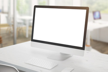 Fototapeta premium Modern computer display on white office desk. Isolated screen for mockup, app or web site design presentation. Office interior in background.
