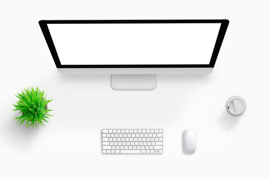 Top view scene of work desk. Computer display with isolated screen for mockup. Plant, keyboard, mouse and coffee beside. Free space middle for text.