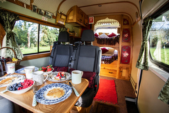 Interior view of camper van with breakfast on table.