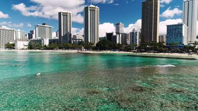 Flying in a big circle, slowly revealing the buildings on Waikiki beach, Hawaii.