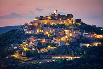 Croatia. Vintage Motovun walled city fortress on the hill. Picturesque evening sunset landscape....