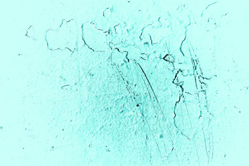 Vintage azure background. Rough painted wall of turquoise color. Imperfect plane of cyan colored. Uneven old decorative toned backdrop of aqzure tint. Texture of teal hue. Ornamental stony surface.