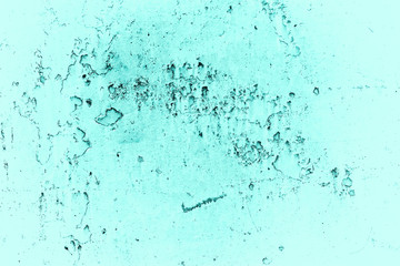 Vintage azure background. Rough painted wall of turquoise color. Imperfect plane of cyan colored. Uneven old decorative toned backdrop of aqzure tint. Texture of teal hue. Ornamental stony surface.