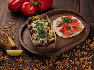 Meat and cheese with baked potatoes and fresh vegetables