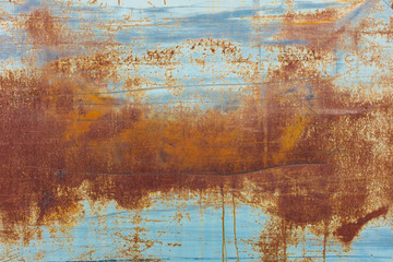 Brown rusting patches on an old wall,Scratch and rust markings on old metal wall, close up