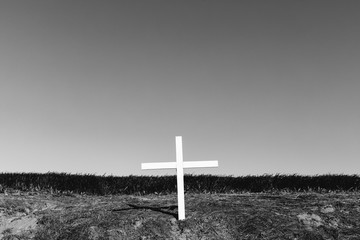 A cross on a hillside, a grave site in open country,Field