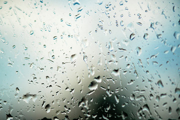 Glass with natural water drops. Condensate drips on the clear glass window.