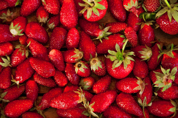 Natural texture of ripe strawberries. Banner of strawberries in a wooden box close-up and copy space.