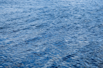 Light playing on the sea surface. Water surface. Sea surface. Water background. Blue water surface. 