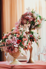 bouquet of flowers in vase on wooden table