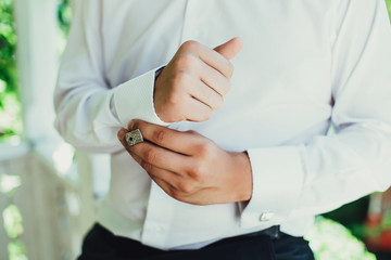 business man buttoning his shirt