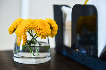 bouquet of flowers in vase on wooden table