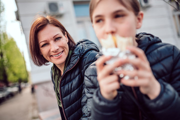 Woman sitting on the street with her daughter