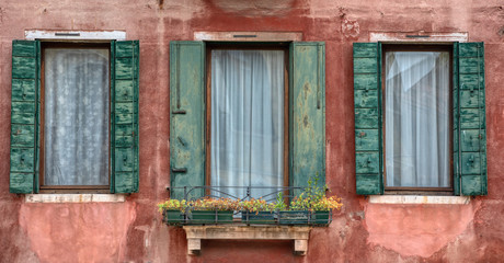 Fototapeta na wymiar Three Windows with Green Shutters of Venice
