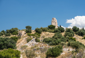 Fototapeta na wymiar Monument of Filopappos above the trail on the summit of Filopappou Hill