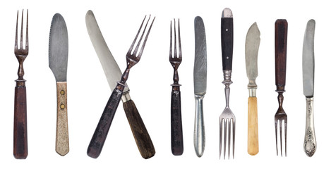 Vintage worn out knifes and forks isolated on a white background. Retro silverware