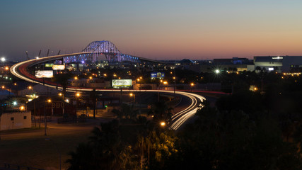 Obraz premium Streaked lights over bridge of early or late night traffic