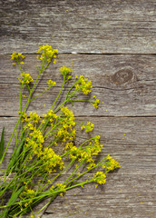 Beautiful bouquet of bright wildflowers, on wooden table on rustic background. Top view.