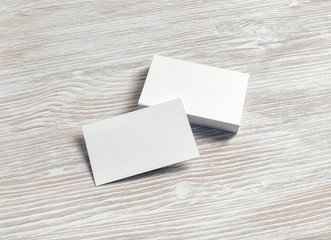 Blank business cards template on light wood table background. Template for graphic designers portfolios.