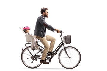 Fototapeta premium Father riding a child in a bicycle child's seat