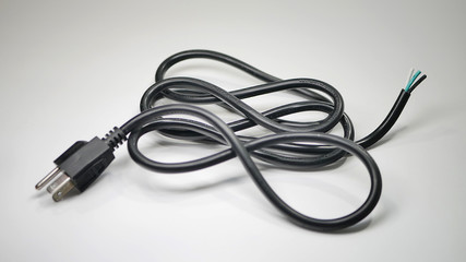 A black power cord with stripped wires on one end with metal prongs designed to plug into wall socket on the other.