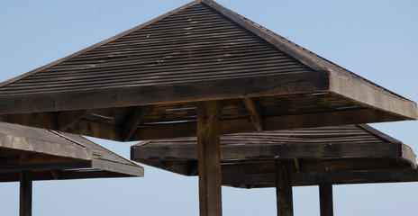 Obraz premium Wooden umbrellas on the beach.