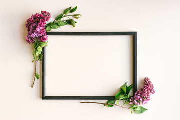 Flowers composition. Frame on white background. Lilac flowers and a white satin ribbon bow. Valentine's day, mother's Day, women's day, spring concept. Flat position, top view, copy space