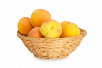 Apricots in bowl isolated on white background