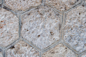 wall with hexagonal cells marked on the stone